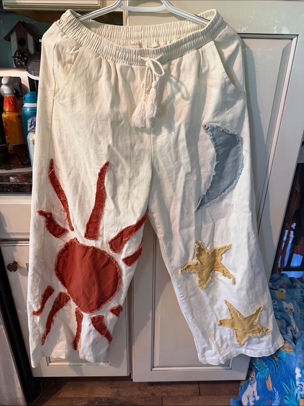 Cream Boot-Flare Pants with Sun, Moon & Star Appliqués